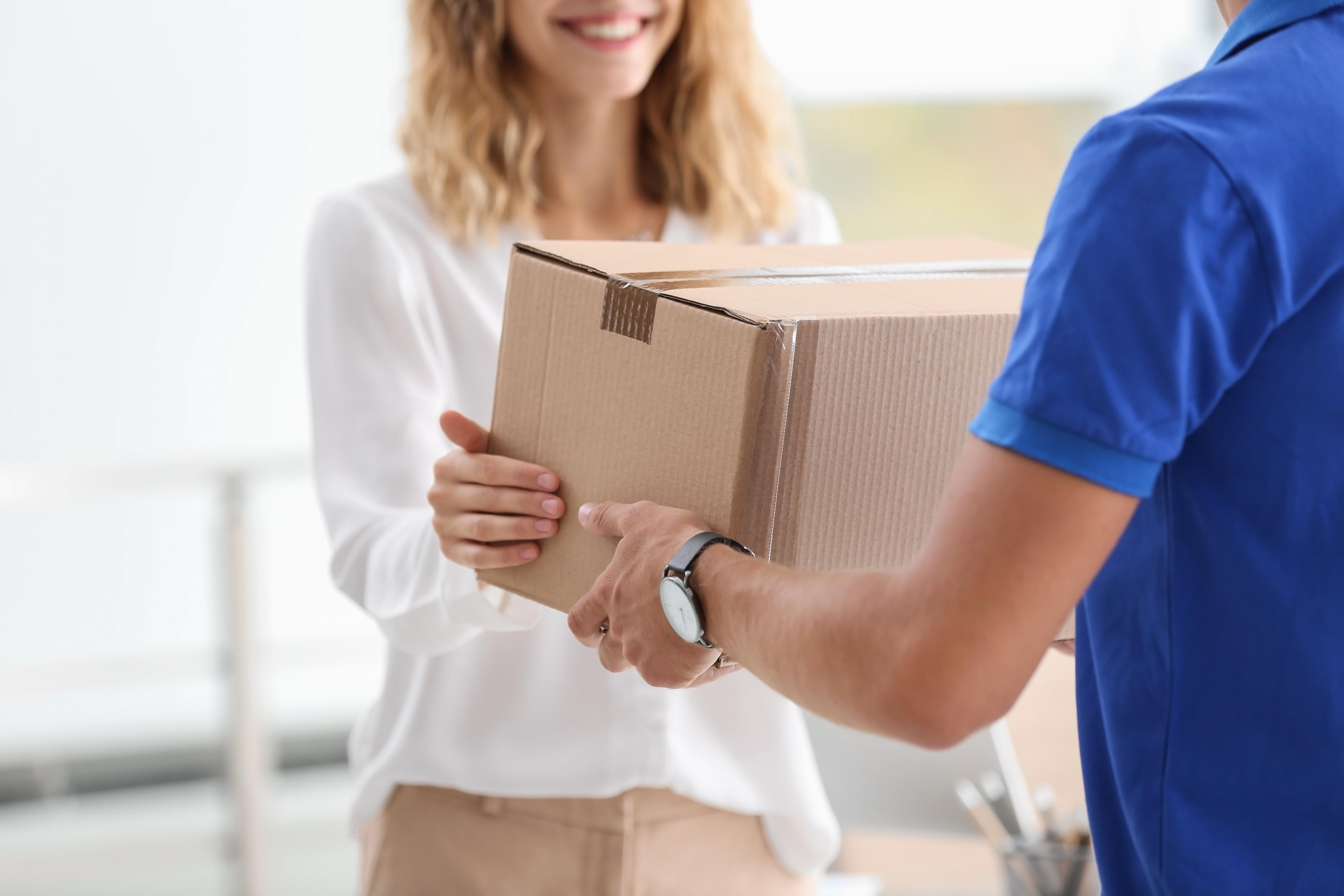 A lady is receiving a box shows that eCommerce business can be successful with lease-to-own solutions like Acima Leasing. 